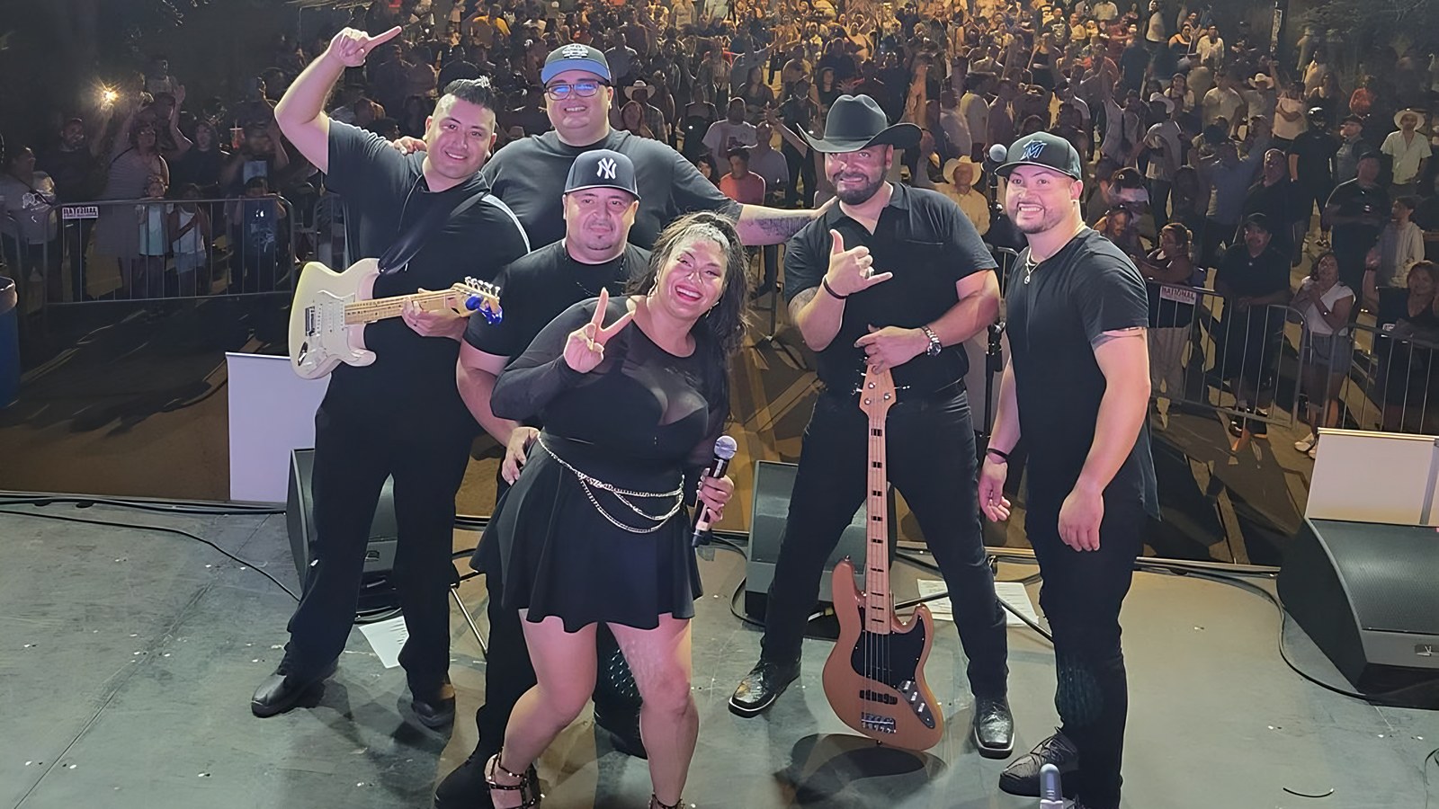 La Obra de Selena on stage in front of a packed street-festival crowd